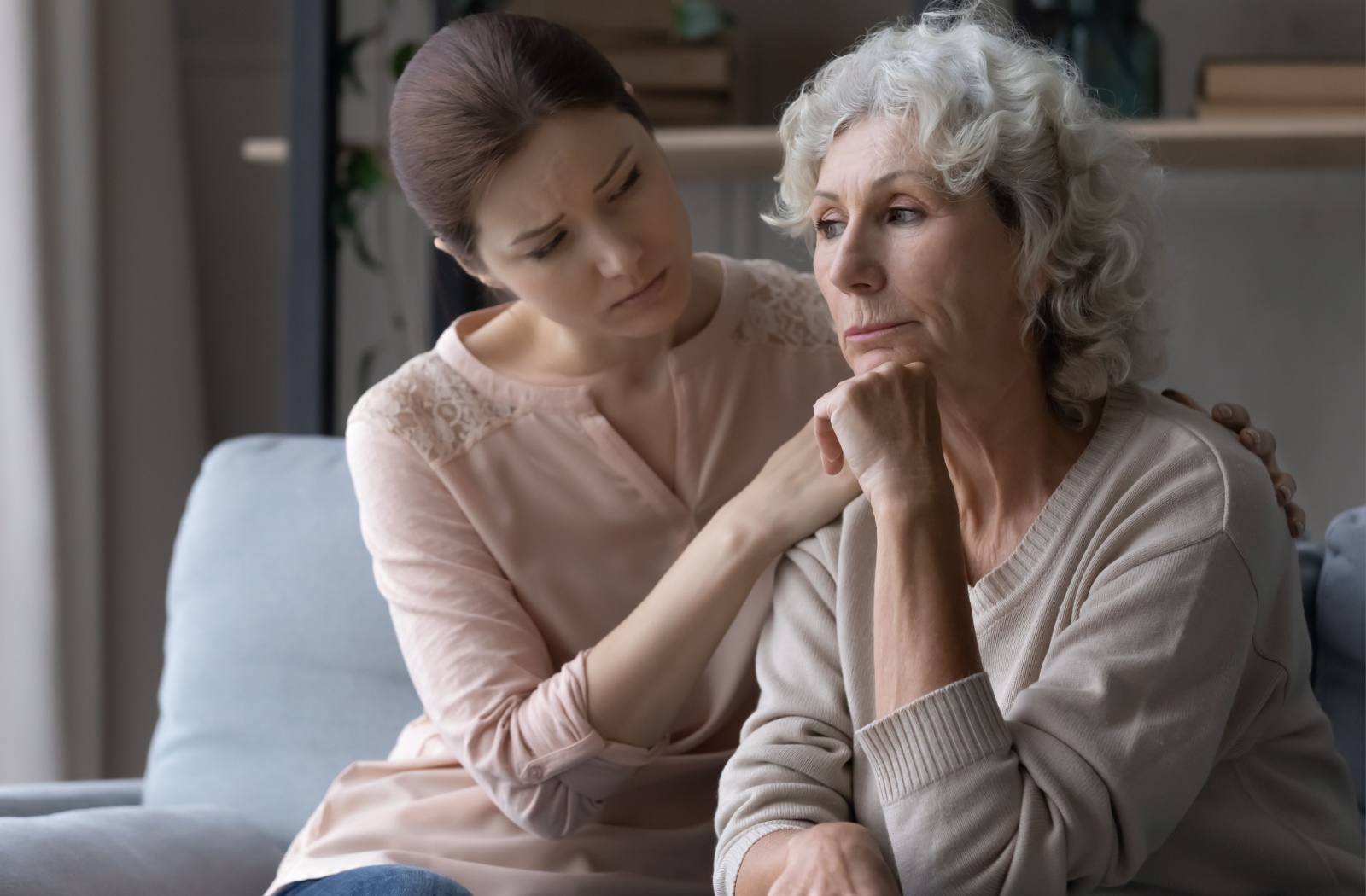 A caregiver supporting their older parent, dealing with caregiver guilt and fatigue.