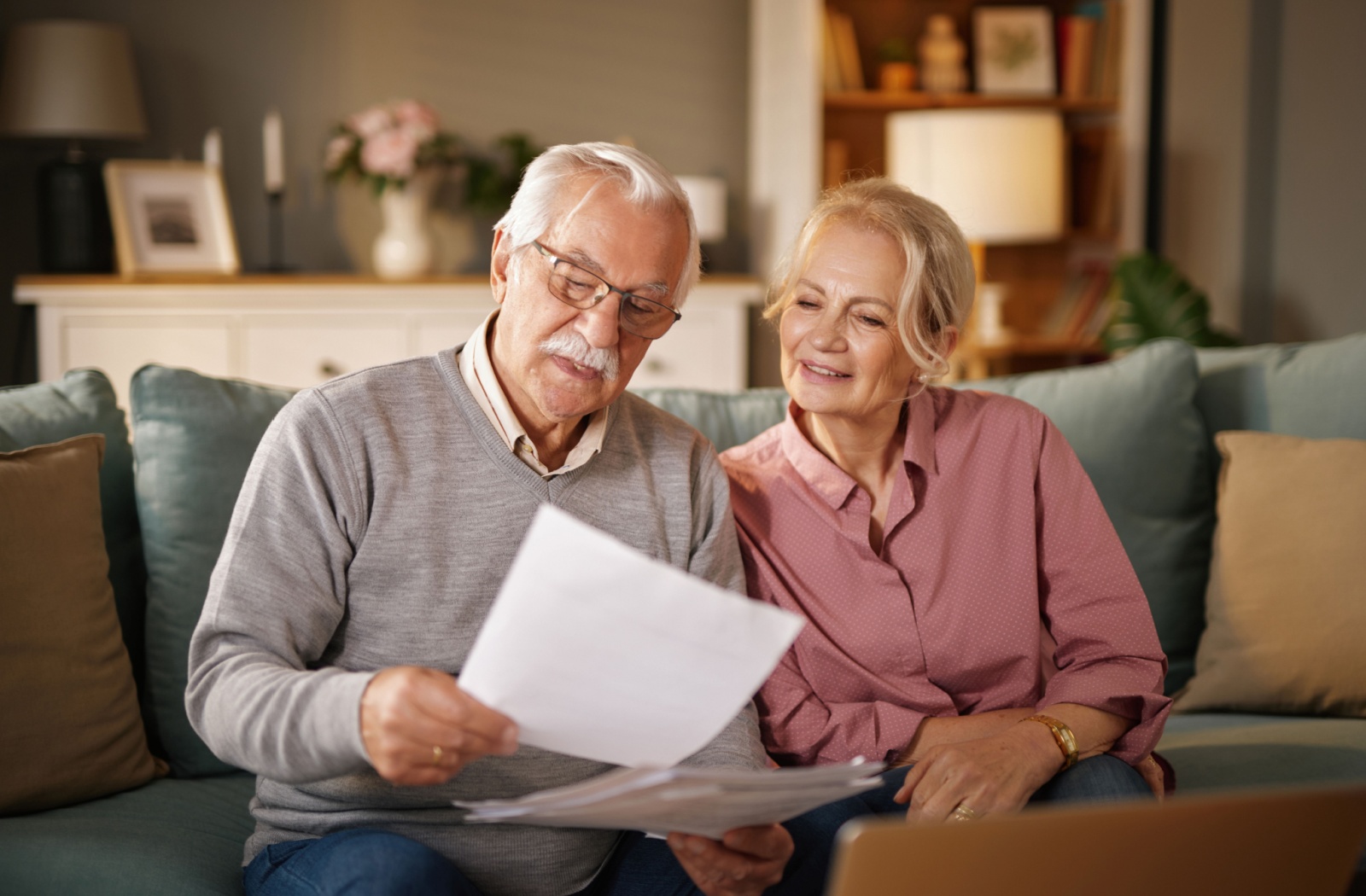 A senior couple reviews an assisted living community brochure